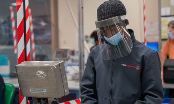 IDEXX employee wearing a mask and face shield